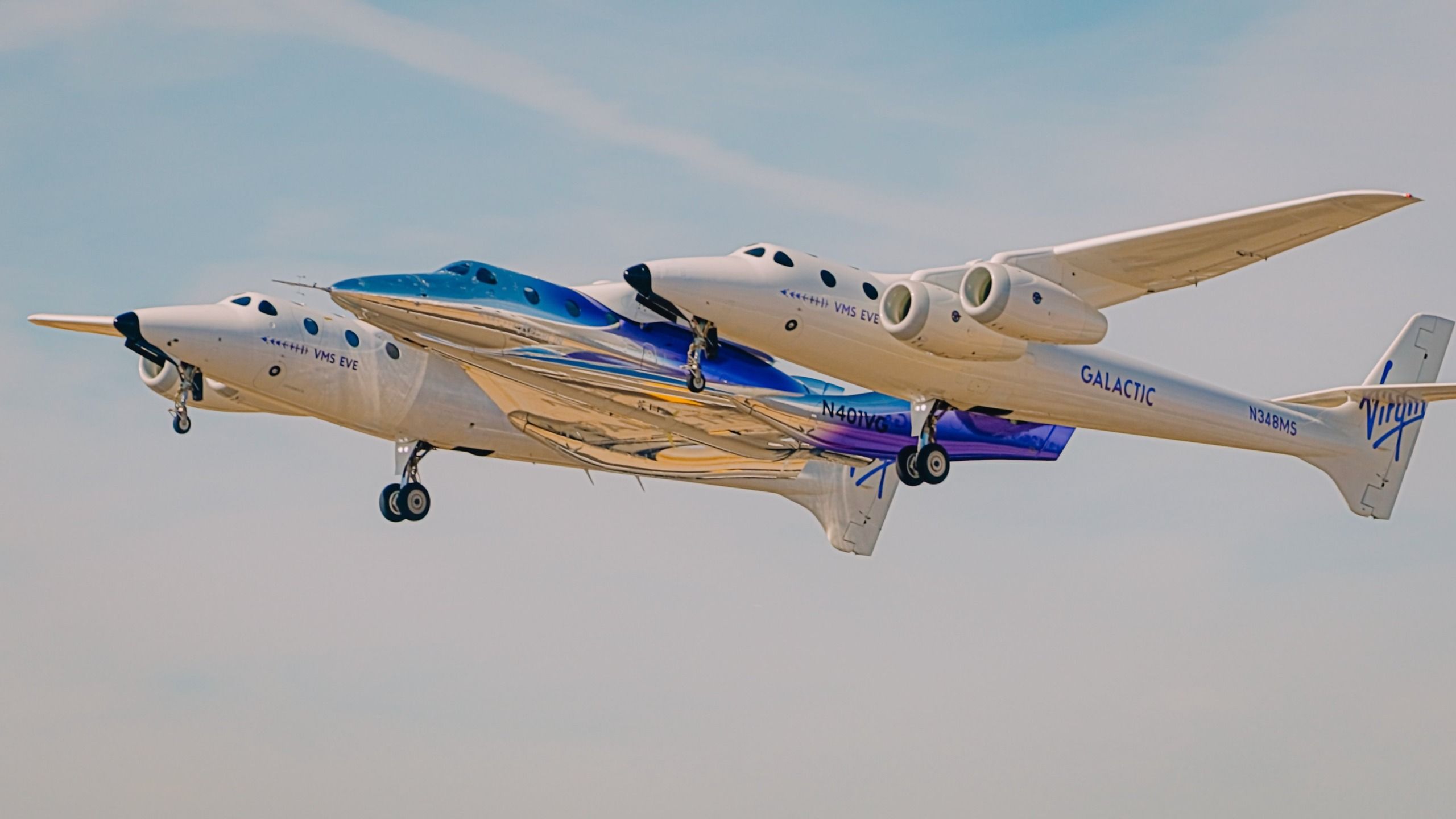 A new space plane rides beneath its carrier aircraft
